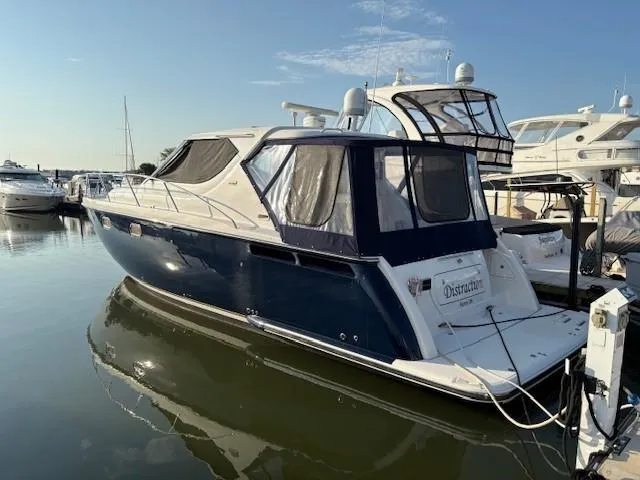 Slide: The Image of 2009 Tiara Yachts 4300 Sovran docked in a marina, side view. - 2