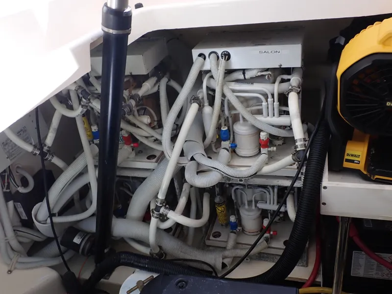 Slide: The Image of Engine compartment of a 2009 Tiara Yachts 4300 Sovran, showcasing complex piping and machinery. - 21