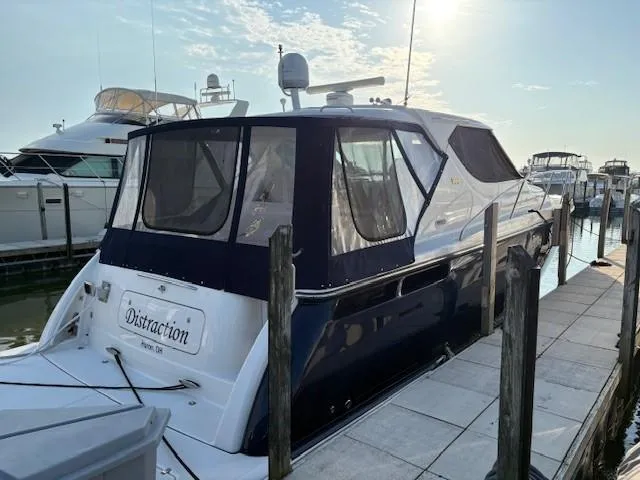 Slide: The Image of 2009 Tiara Yachts 4300 Sovran docked at marina under clear sky. - 3