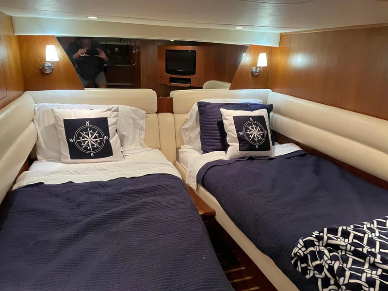 Slide: The Image of Interior of 2009 Tiara Yachts 4300 Sovran with twin beds and nautical-themed decor. - 5