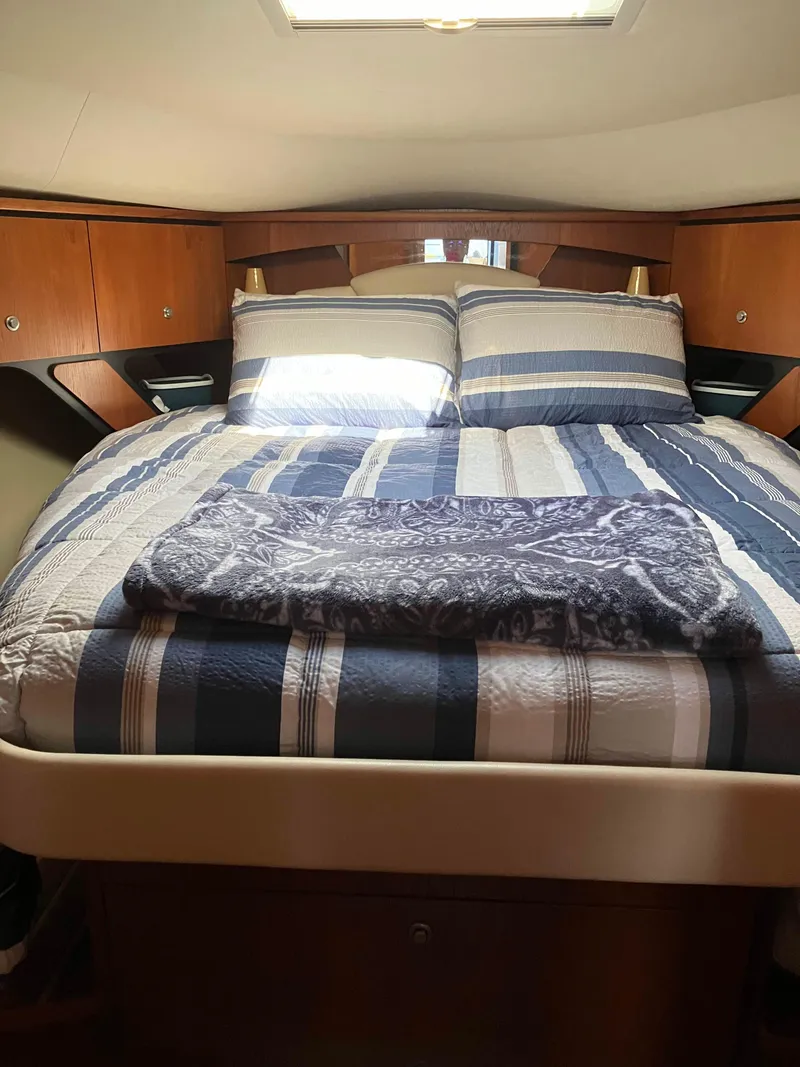 Slide: The Image of Luxurious cabin interior of 2009 Tiara Yachts 4300 Sovran with striped bedding. - 6