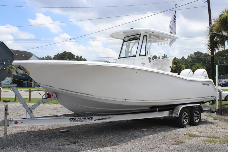 The Image of 2026 Tidewater 272 LXF boat on trailer, parked outdoors under a cloudy sky. - 0
