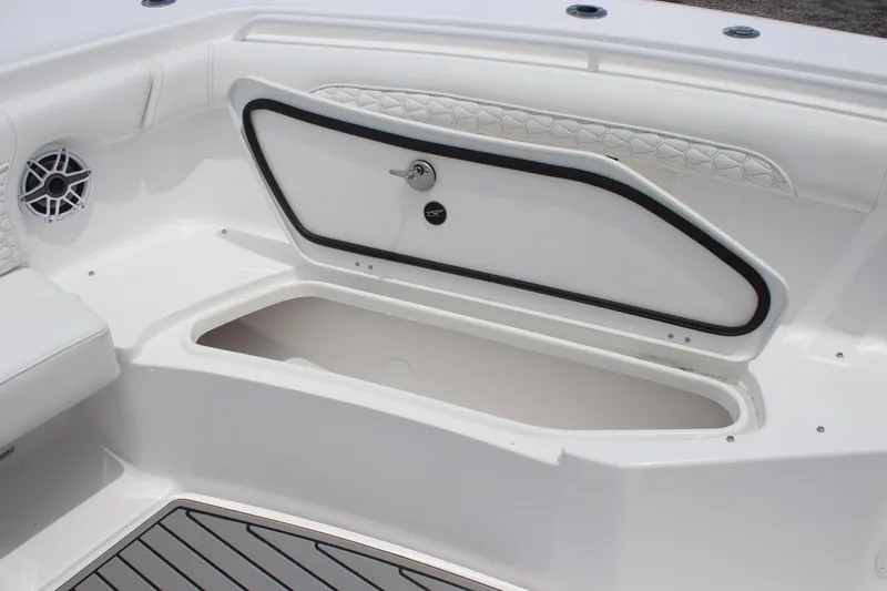 Slide: The Image of 2026 Tidewater 272 LXF boat storage compartment with sleek design and speaker detail. - 12
