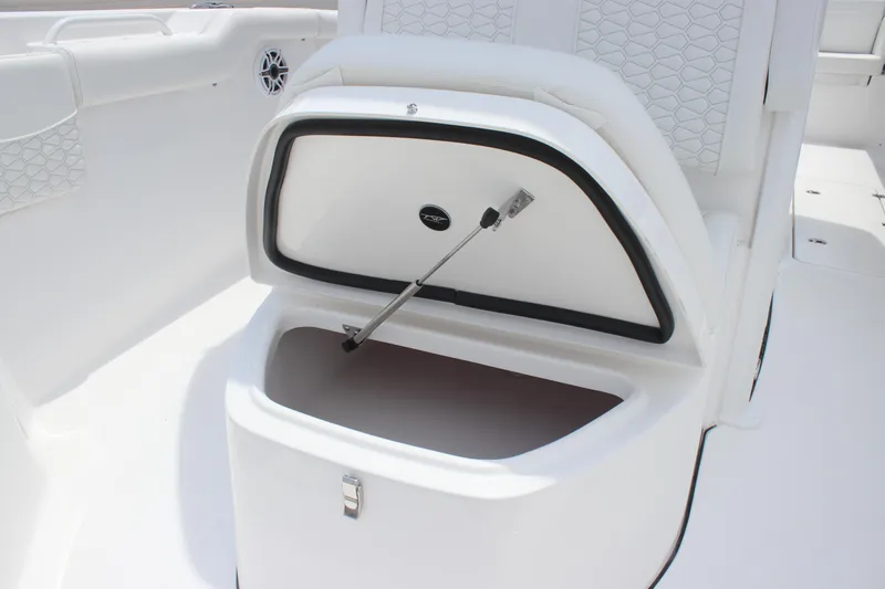 Slide: The Image of Open storage compartment on 2026 Tidewater 272 LXF boat, featuring sleek white interior design. - 13