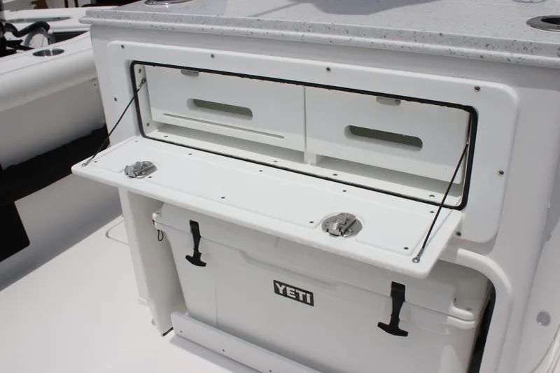 Slide: The Image of 2026 Tidewater 272 LXF boat with Yeti cooler and storage compartment. - 19