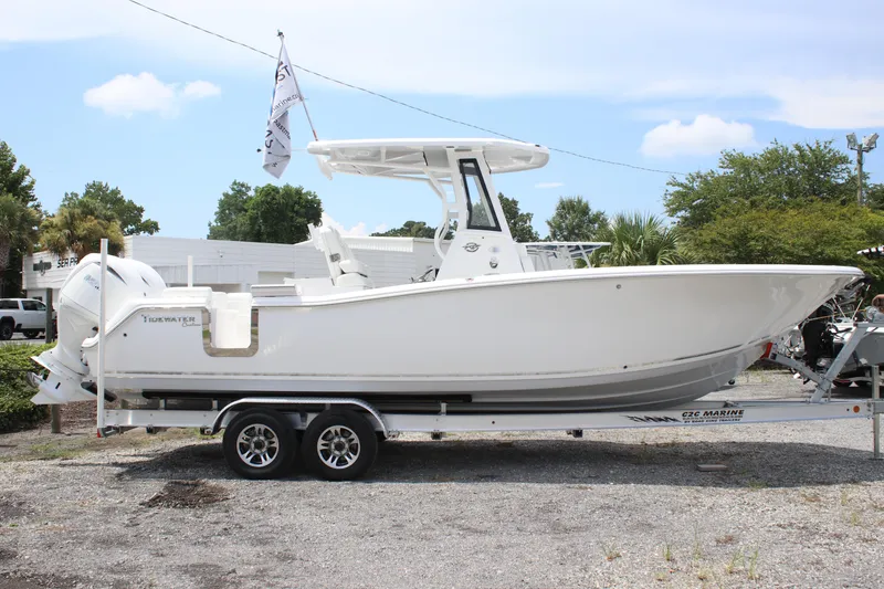 Slide: The Image of 2026 Tidewater 272 LXF boat on trailer, parked outdoors under a clear sky. - 2