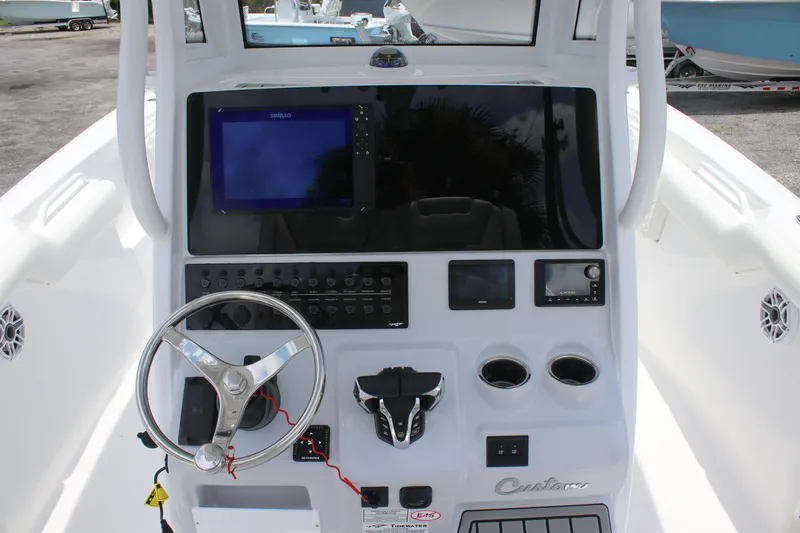 Slide: The Image of 2026 Tidewater 272 LXF boat dashboard with steering wheel and electronic controls. - 21