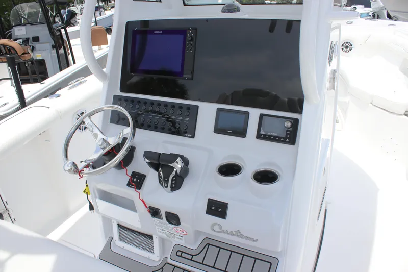 Slide: The Image of 2026 Tidewater 272 LXF boat dashboard with steering wheel and electronic controls. - 22