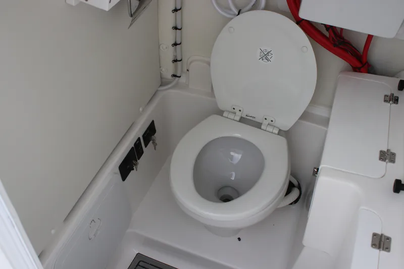 Slide: The Image of 2026 Tidewater 272 LXF boat interior with marine toilet and storage compartments. - 27