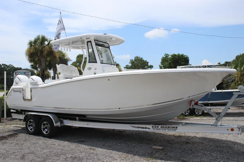 Slide: The Image of 2026 Tidewater 272 LXF boat on trailer, parked outdoors under clear sky. - 3