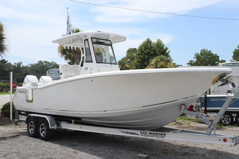 Slide: The Image of 2026 Tidewater 272 LXF boat on trailer, parked outdoors under clear sky. - 5