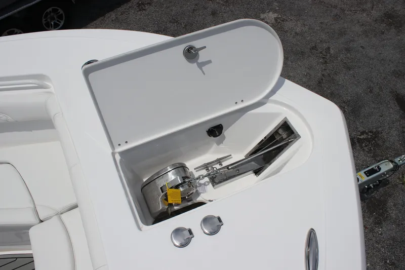 Slide: The Image of 2026 Tidewater 272 LXF boat anchor compartment with open hatch, showcasing storage space. - 7