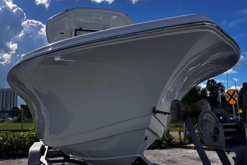Slide: The Image of 2026 Tidewater 220 CC Adventure boat on trailer under blue sky. - 6