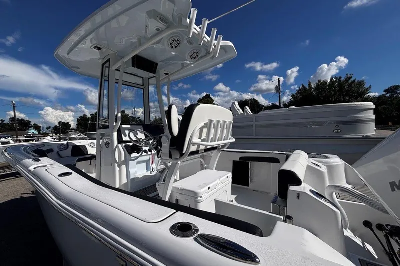 Slide: The Image of 2026 Tidewater 220 CC Adventure boat with sleek design and modern features under a clear blue sky. - 7