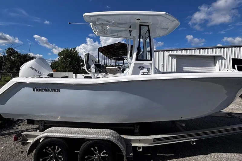 Slide: The Image of 2026 Tidewater 220 CC Adventure boat on trailer under blue sky. - 8