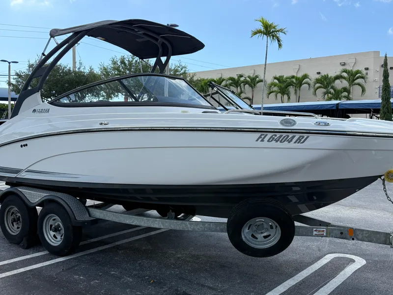 Slide: The Image of 2017 Yamaha Boats 212 Limited S on trailer, parked outdoors. - 1