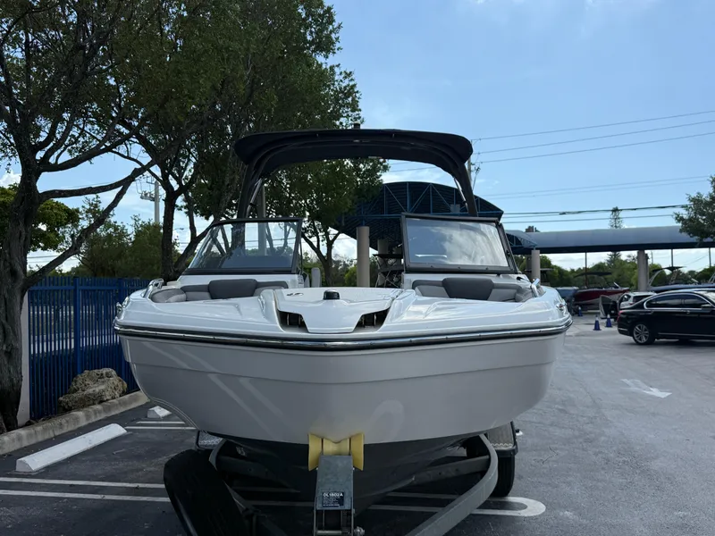 Slide: The Image of 2017 Yamaha Boats 212 Limited S on trailer in parking lot, surrounded by trees. - 12