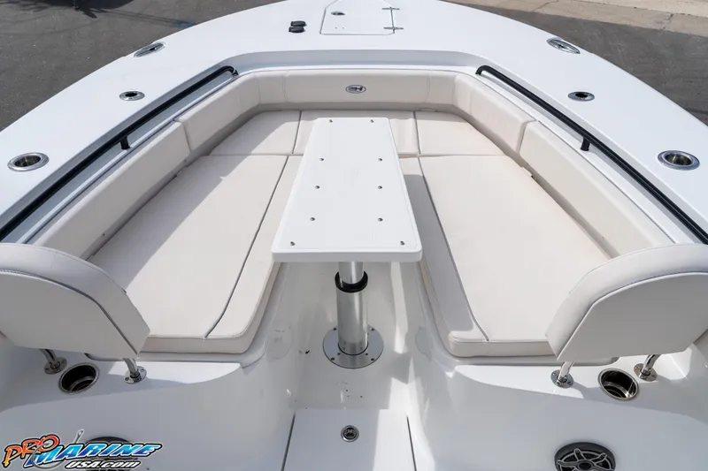 Slide: The Image of 2026 Sea Hunt Gamefish 30 boat interior with cushioned seating and table. - 16