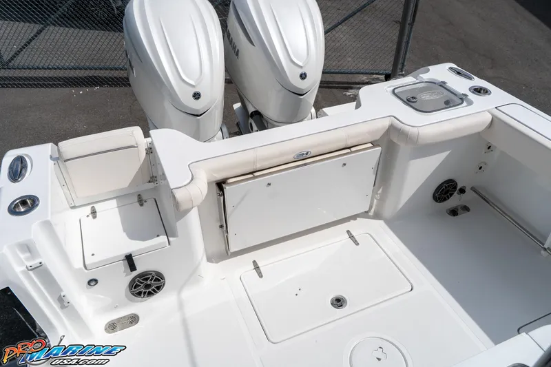 Slide: The Image of 2026 Sea Hunt Gamefish 30 boat deck with dual engines and storage compartments. - 25