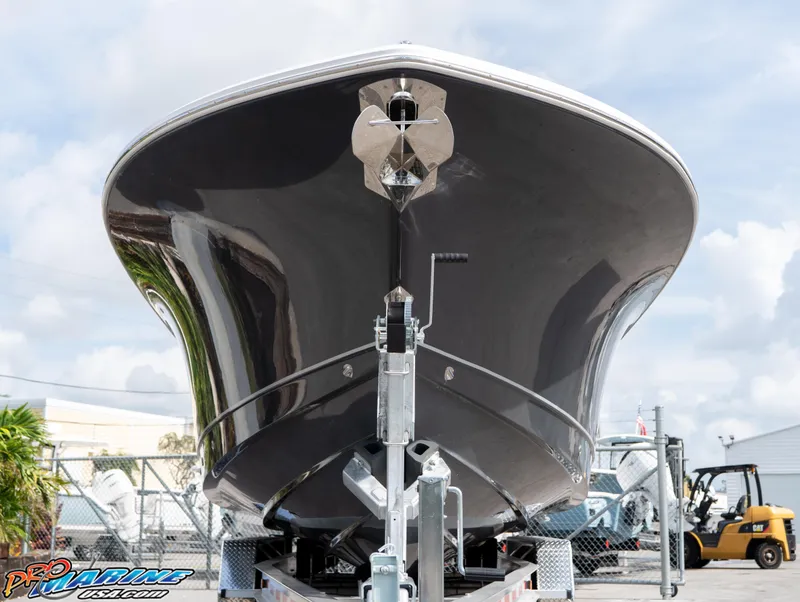 Slide: The Image of 2026 Sea Hunt Gamefish 30 boat on trailer, viewed from the front, in a marina setting. - 5