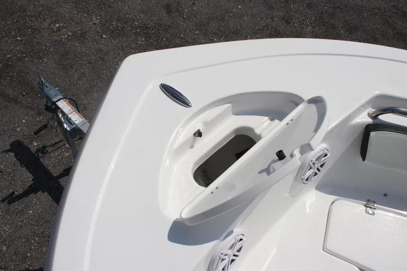 Slide: The Image of 2026 Tidewater 198 CC Adventure boat deck with open storage compartment and speakers. - 12