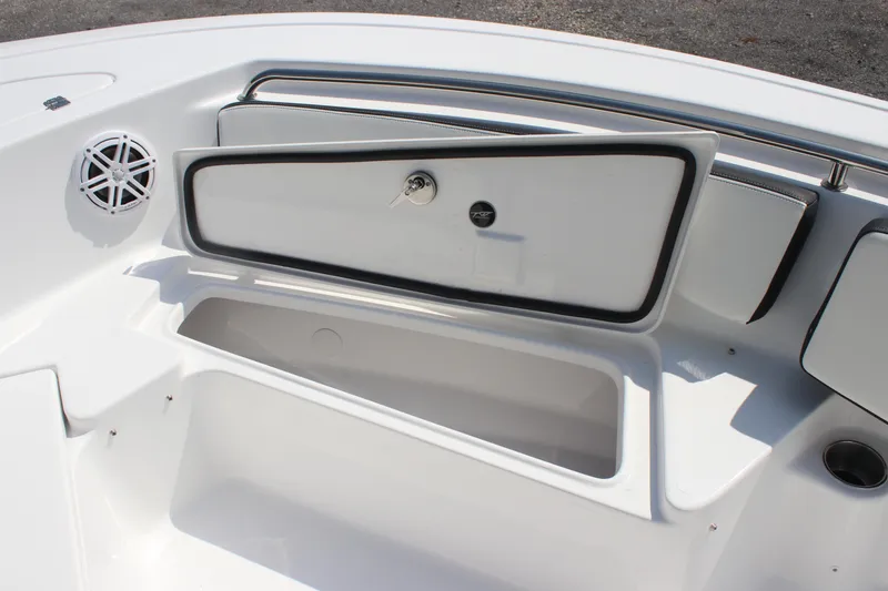 Slide: The Image of 2026 Tidewater 198 CC Adventure boat storage compartment with speaker and cup holder. - 13