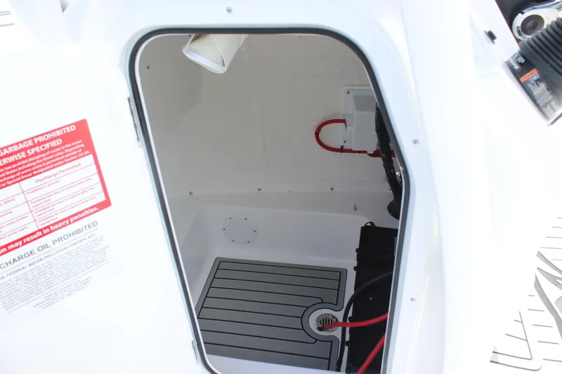 Slide: The Image of 2026 Tidewater 198 CC Adventure boat storage compartment with safety instructions. - 36