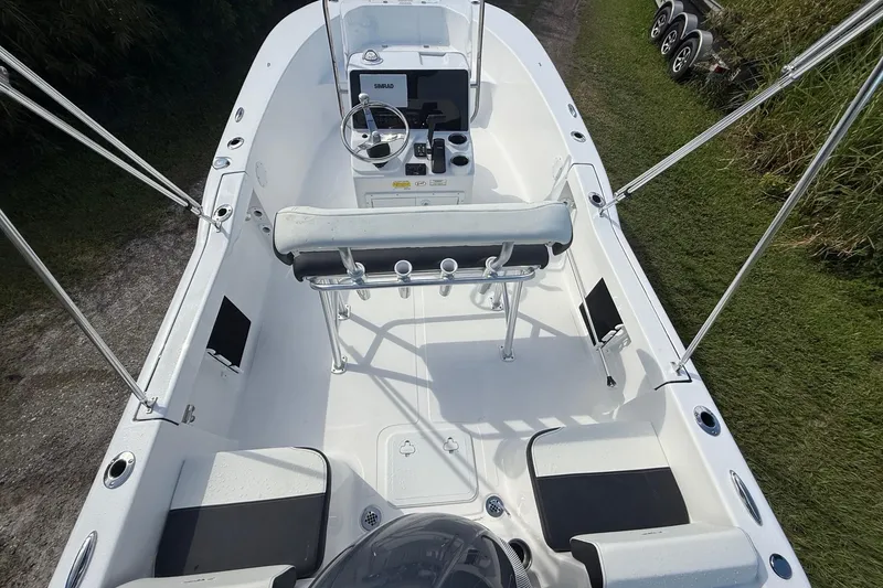 Slide: The Image of 2026 Tidewater 180 CC Adventure boat interior with console and seating, viewed from above. - 14