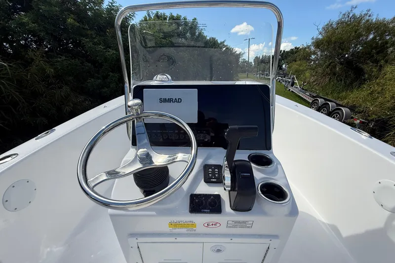Slide: The Image of 2026 Tidewater 180 CC Adventure boat console with steering wheel and Simrad display. - 16