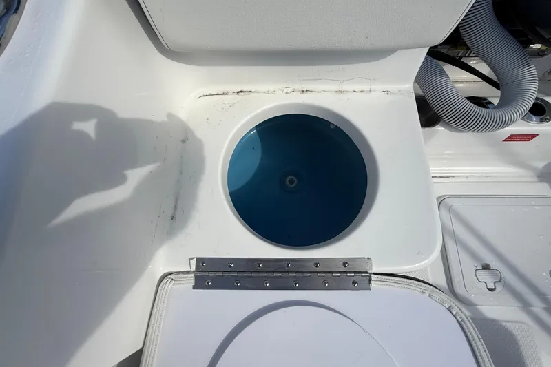 Slide: The Image of 2026 Tidewater 180 CC Adventure boat livewell with open lid and visible plumbing. - 24