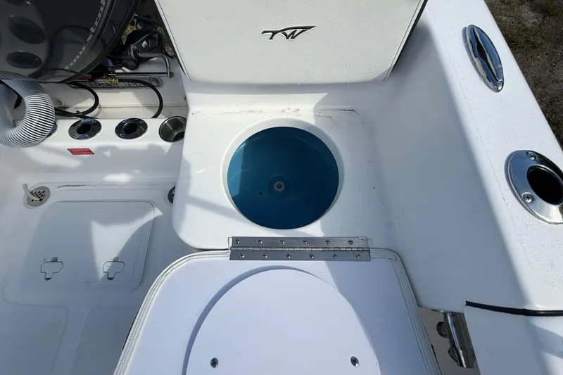 Slide: The Image of 2026 Tidewater 180 CC Adventure boat interior with livewell and rod holders. - 25