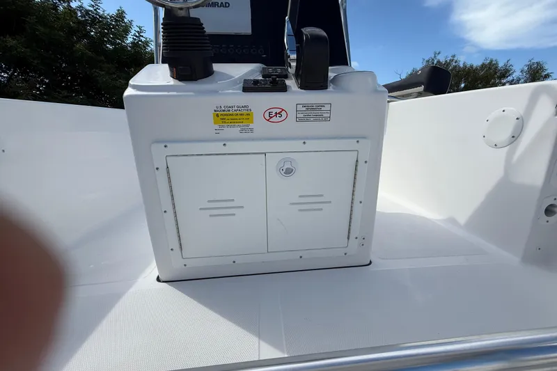 Slide: The Image of 2026 Tidewater 180 CC Adventure boat console with storage compartment and control panel. - 26