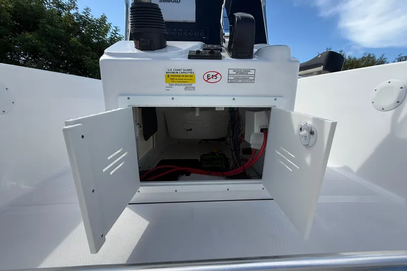 Slide: The Image of 2026 Tidewater 180 CC Adventure boat console with open storage compartment and visible wiring. - 27