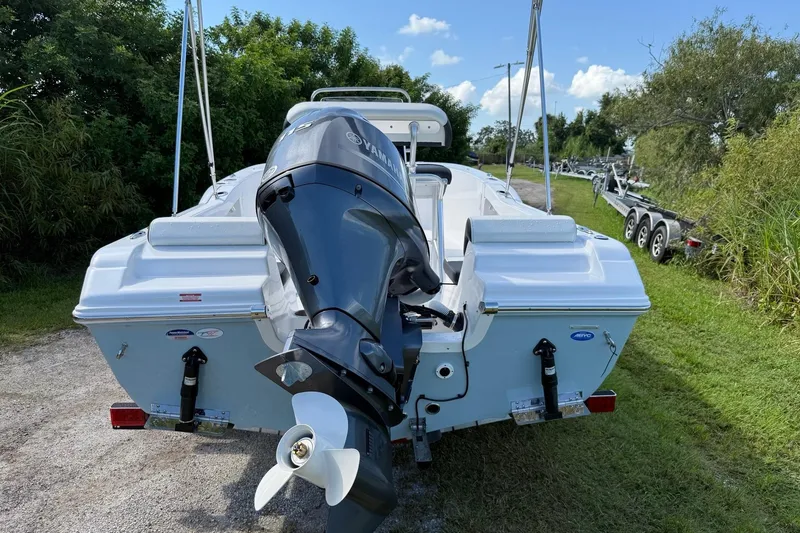 Slide: The Image of 2026 Tidewater 180 CC Adventure boat with Yamaha outboard motor, parked on grass. - 3