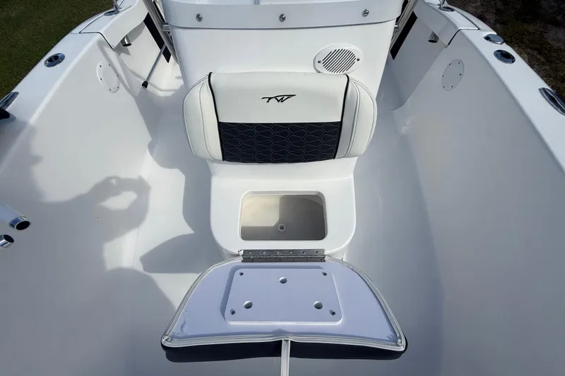 Slide: The Image of 2026 Tidewater 180 CC Adventure boat interior with seating and storage compartment. - 32