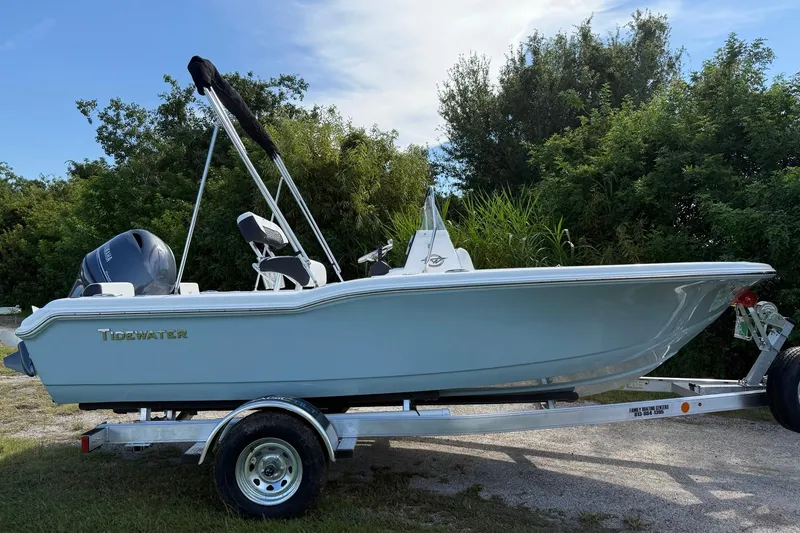 Slide: The Image of 2026 Tidewater 180 CC Adventure boat on trailer, surrounded by greenery. - 6