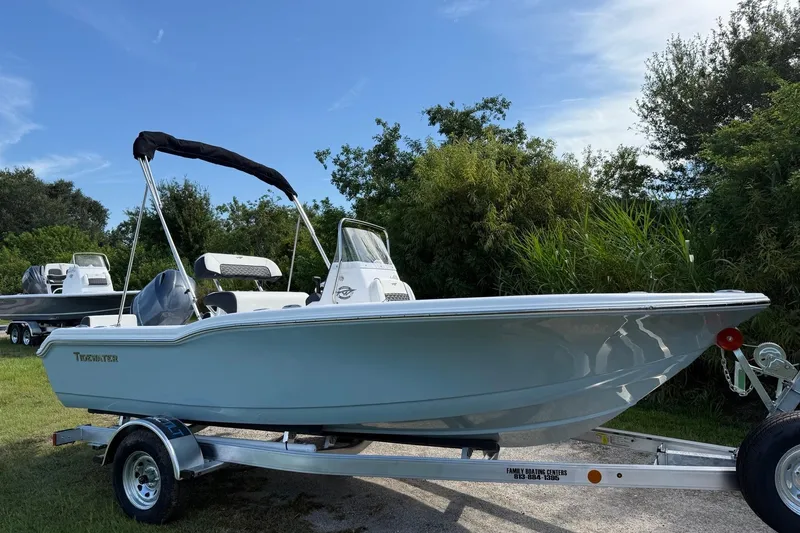 Slide: The Image of 2026 Tidewater 180 CC Adventure boat on trailer, surrounded by greenery. - 7