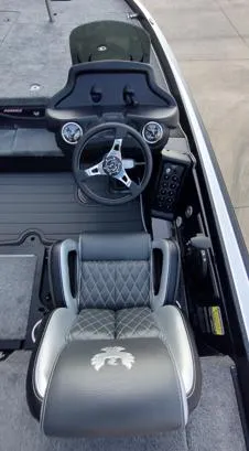 Slide: The Image of 2026 Phoenix 721zxl boat cockpit with steering wheel and cushioned seat. - 5