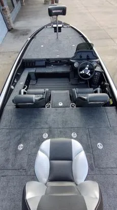 Slide: The Image of 2026 Phoenix 721zxl boat interior with seating and steering wheel, docked on concrete. - 7