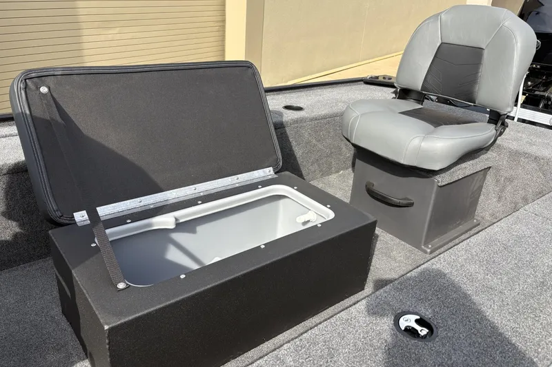 Slide: The Image of 2025 Tracker Panfish 17 boat interior with storage compartment and gray seat. - 3