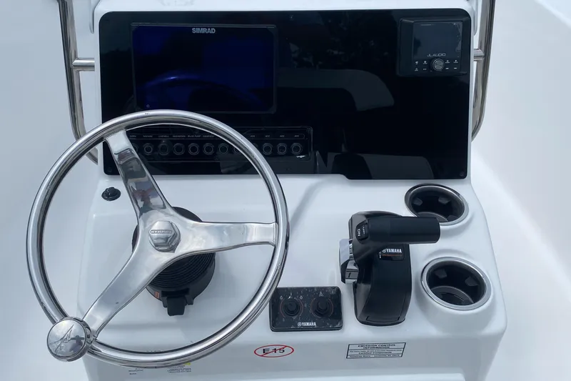 Slide: The Image of 2026 Tidewater 180 CC Adventure boat console with steering wheel and Yamaha controls. - 14