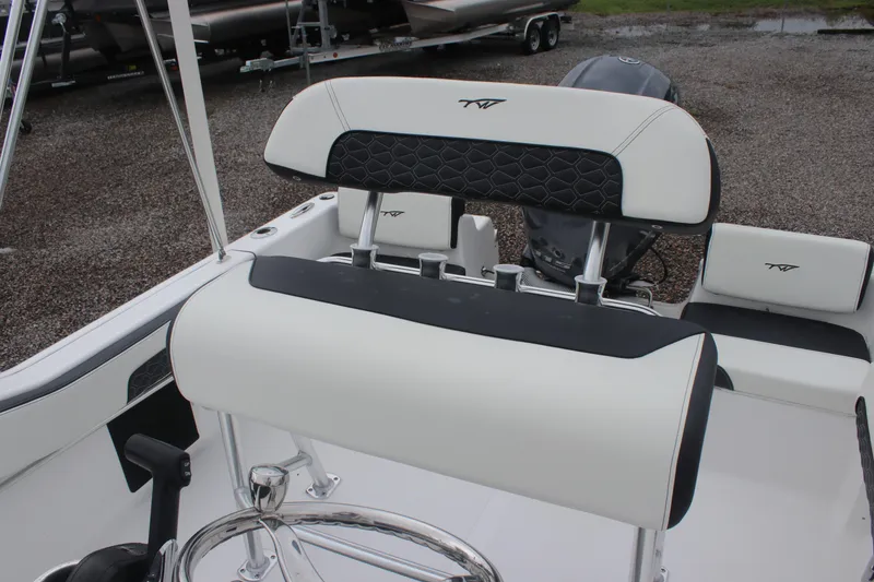 Slide: The Image of 2026 Tidewater 180 CC Adventure boat interior with cushioned seating and steering wheel. - 17