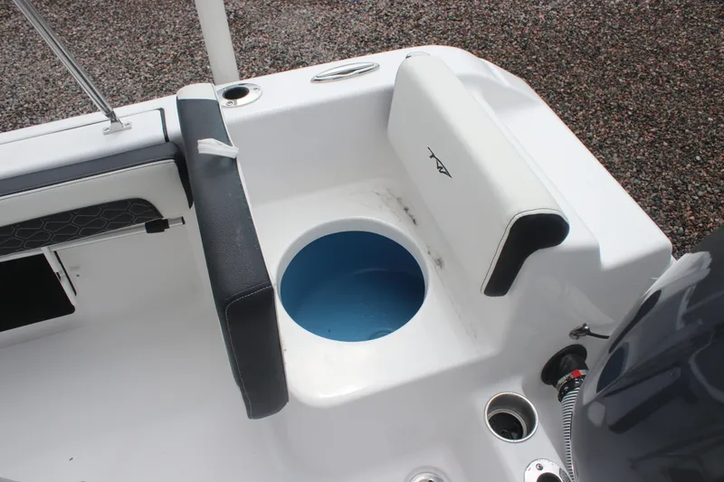 Slide: The Image of 2026 Tidewater 180 CC Adventure boat interior with seating and storage compartment. - 20