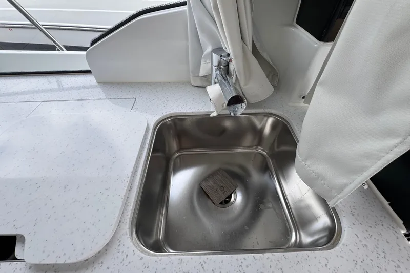 Slide: The Image of 2026 Jeanneau NC 1095 interior cabin with modern wood finish and control panel. - 10