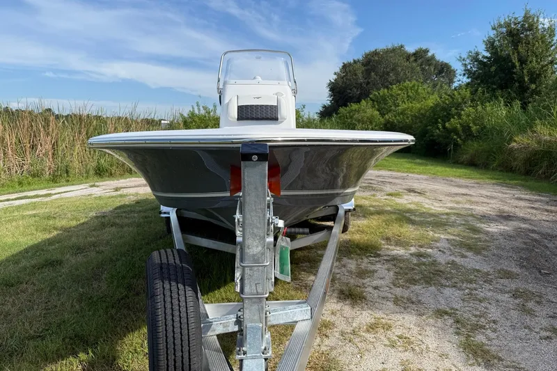 Slide: The Image of 2026 Tidewater 2110 Bay Max boat on trailer, parked on grassy area. - 10