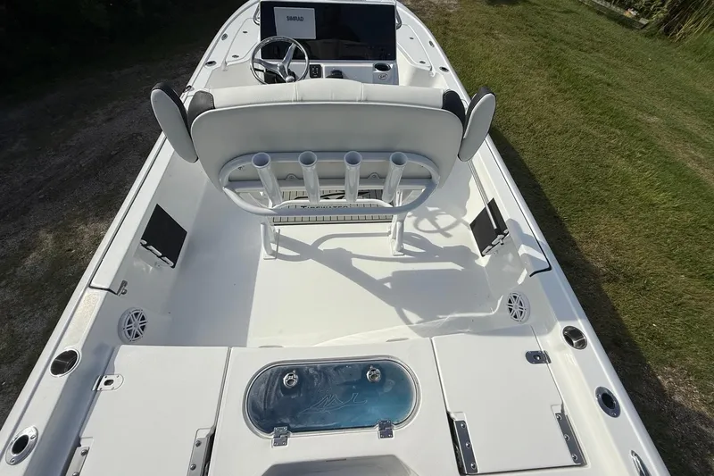 Slide: The Image of 2026 Tidewater 2110 Bay Max boat interior with steering console and seating. - 12
