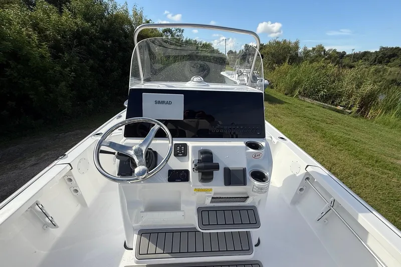 Slide: The Image of 2026 Tidewater 2110 Bay Max boat console with steering wheel and Simrad display. - 14