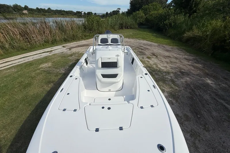 Slide: The Image of 2026 Tidewater 2110 Bay Max boat on grassy shore near a lake. - 19