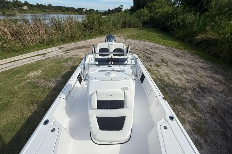 Slide: The Image of 2026 Tidewater 2110 Bay Max boat on grassy shore near a lake. - 20