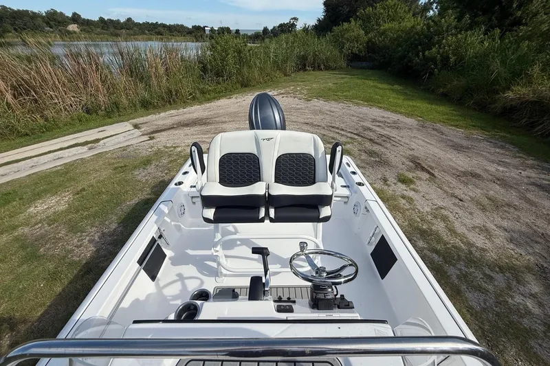 Slide: The Image of 2026 Tidewater 2110 Bay Max boat interior with dual seats and steering wheel. - 21